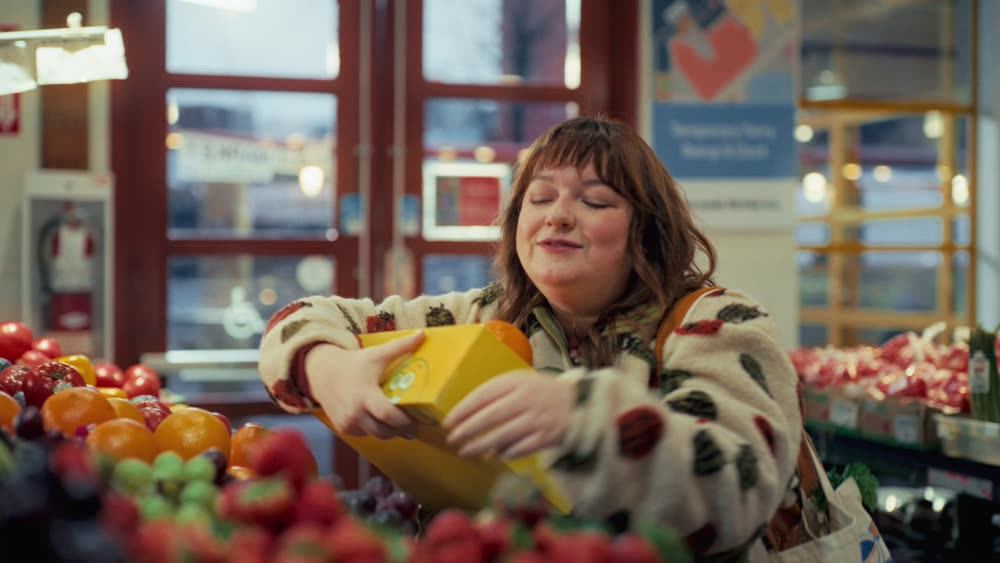 A woman picking fruit at a market